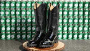 Shiny boots on a wood pedestal