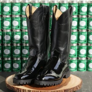 Shiny boots on a wood pedestal