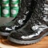 Shiny boots on a wood pedestal